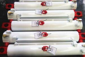 Refurbished hydraulic cylinders from a longwall mining customer after hydraulic cylinder repair, cleaned and tagged ready for service.